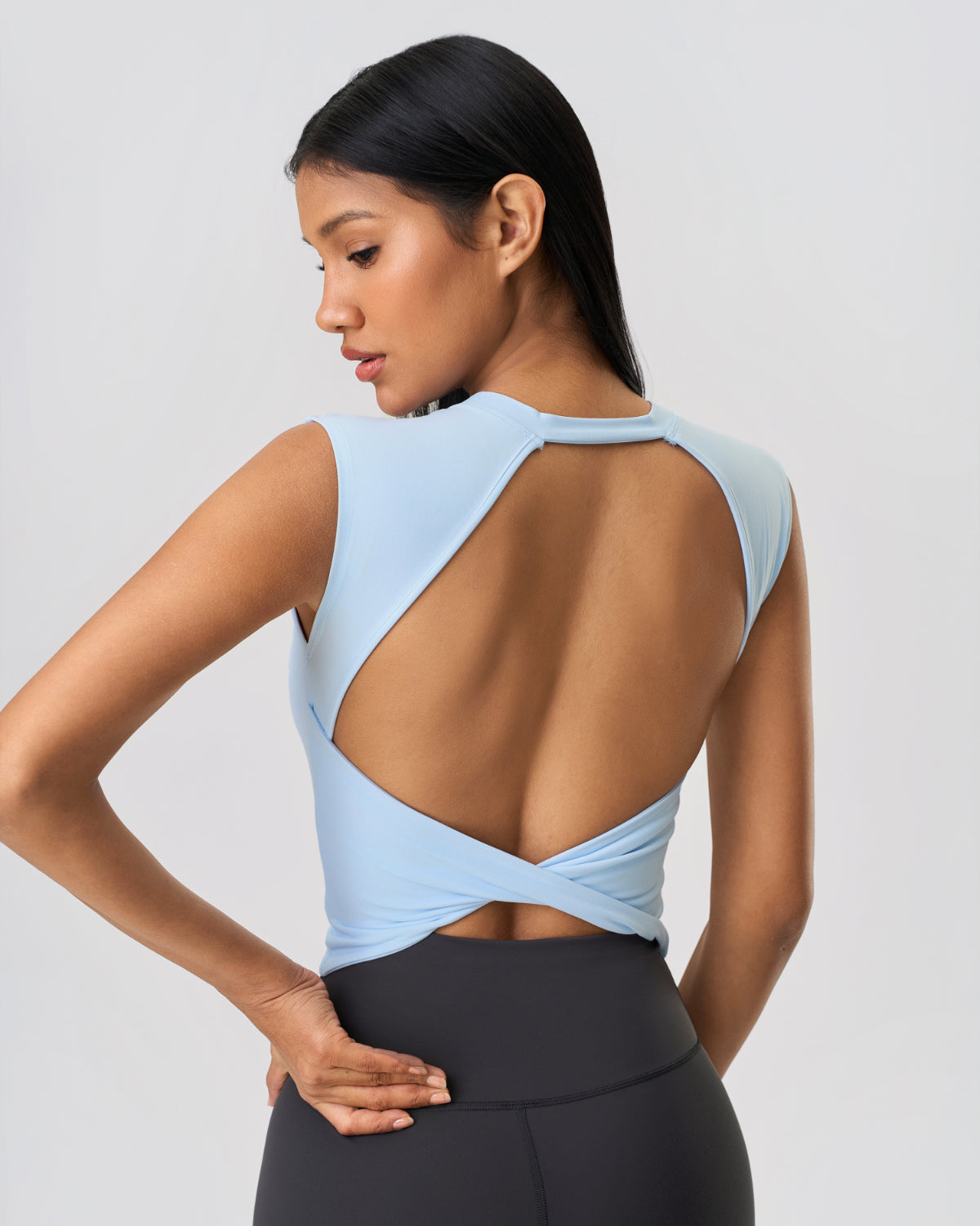 RYZ Swoosh open-back activewear tank in sky blue, designed for Indian summer breathability