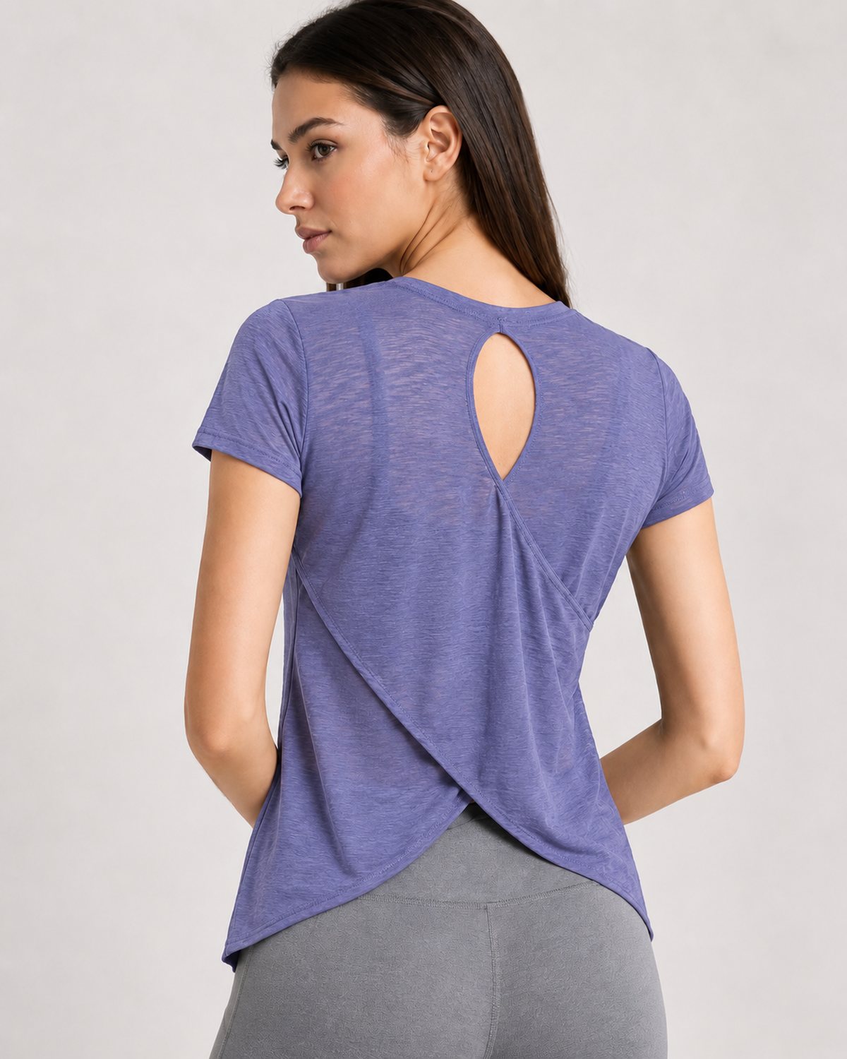 Woman wearing RYZ Softretch Cross-Flow Breeze Tee in Purple, back view, cross-cutout back