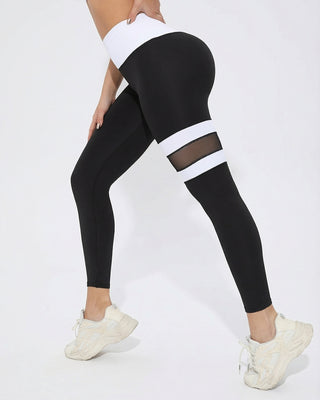 Woman wearing RYZ Original Core Mesh-Band high-waist black leggings with mesh thigh panels, front view