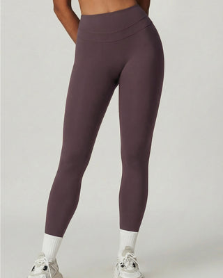 Woman wearing RYZ Core Sculpt-Fit no-front-seam purple high-waist leggings, front view