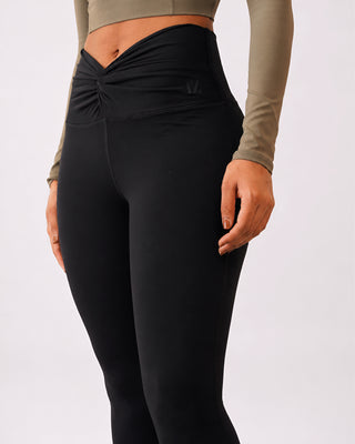Woman wearing RYZ Original Core Knot-Blot Designer black squat-proof leggings, front view