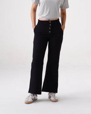 Woman wearing RYZ Swoosh lightweight warm pants in black, front view