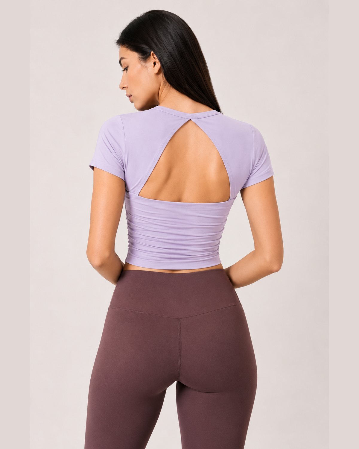 Woman wearing RYZ Enhance Mesh Fusion Top in Lavender, back view, open cut-out back