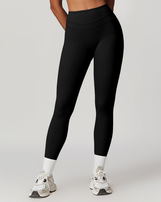 Woman wearing RYZ Core Sculpt-Fit no-front-seam black high-waist leggings, front view