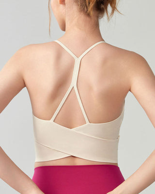 Woman wearing RYZ Original Swoosh Contour Y-back padded wrap tank in ivory, back view
